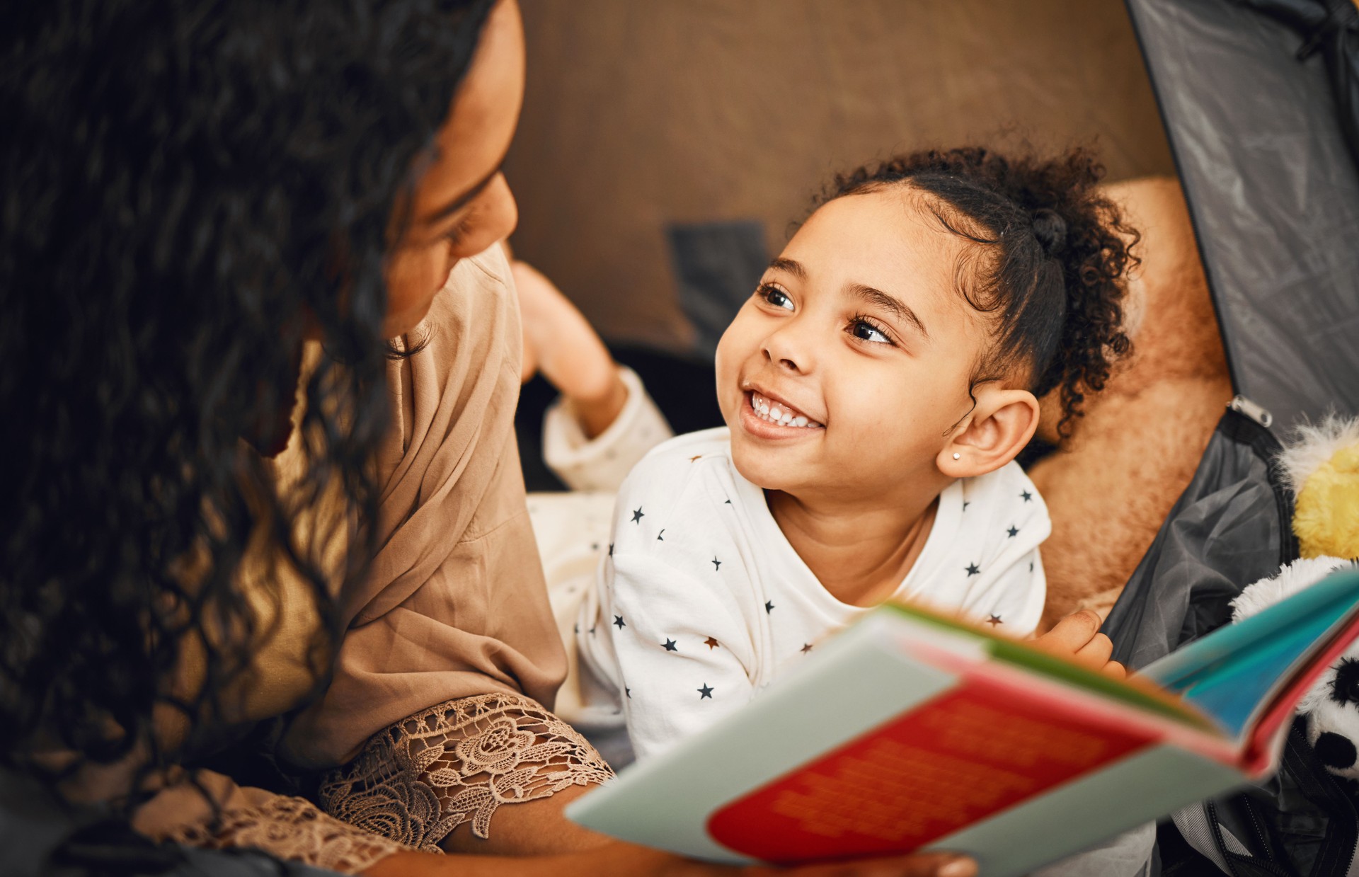 Happy family, mother or child reading story book, cartoon comic books and bonding with mom, mama or parents. Love, youth development and bedtime storytelling for kid listening to fairytale fantasy
